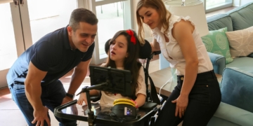 Clara, pequeña con parálisis cerebral, junto a sus padres